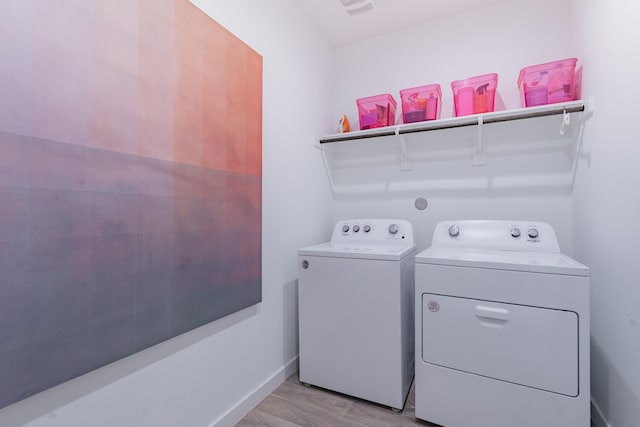 14205 Wonder Lake Ln, Conroe, TX 77384 - laundry area with separate washer and dryer and light wood-style floors
