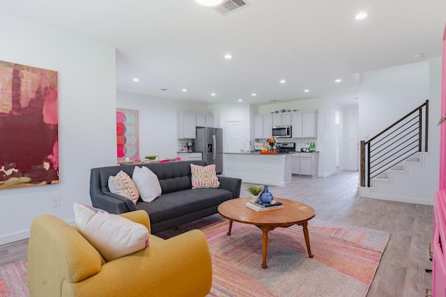 14205 Wonder Lake Ln, Conroe, TX 77384 - living area featuring light wood-style floors, recessed lighting, and stairs