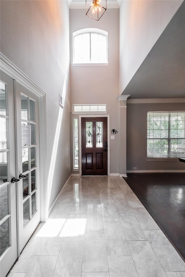 2506 Foxcrest Dr, Katy, TX 77494 - entryway featuring marble look tiles, ornamental molding, a towering ceiling, and french doors