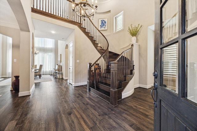13627 Saddlebred Springs Ln, Cypress, TX 77429 - entrance foyer featuring a chandelier, arched walkways, a towering ceiling, dark wood finished floors, and stairs