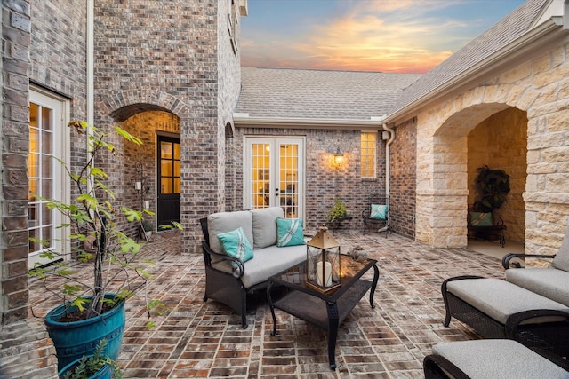 13627 Saddlebred Springs Ln, Cypress, TX 77429 - patio terrace at dusk featuring french doors, outdoor lounge area, and a patio area