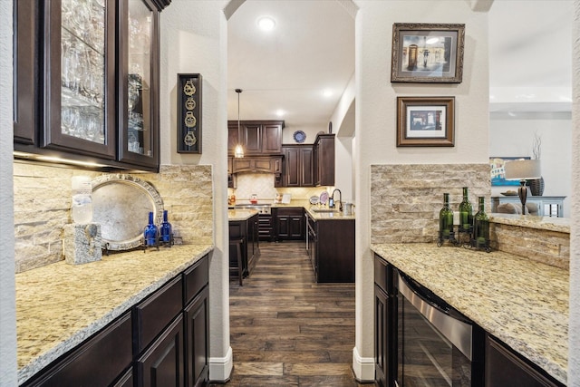 13627 Saddlebred Springs Ln, Cypress, TX 77429 - bar featuring wine cooler, dark wood-type flooring, backsplash, and arched walkways