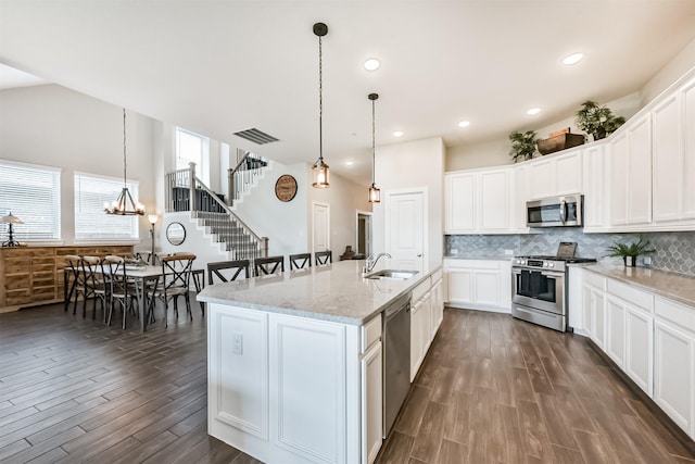 10119 Napier Dr, Iowa Colony, TX 77583 - kitchen featuring stainless steel appliances, dark wood-style floors, backsplash, decorative light fixtures, and recessed lighting