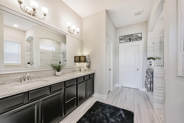 10119 Napier Dr, Iowa Colony, TX 77583 - bathroom featuring a tile shower and double vanity