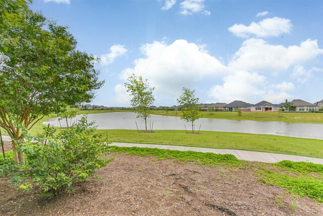10119 Napier Dr, Iowa Colony, TX 77583 - view of grassy yard featuring a water view and a residential view