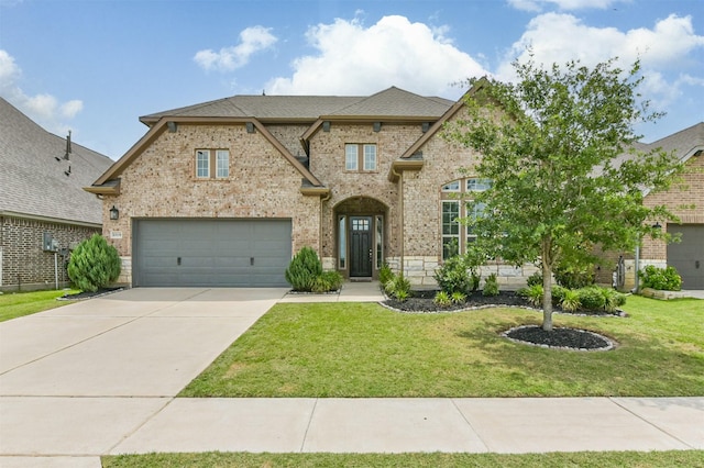 10119 Napier Dr, Iowa Colony, TX 77583 - french country inspired facade with brick siding, a front lawn, driveway, a garage, and roof with shingles
