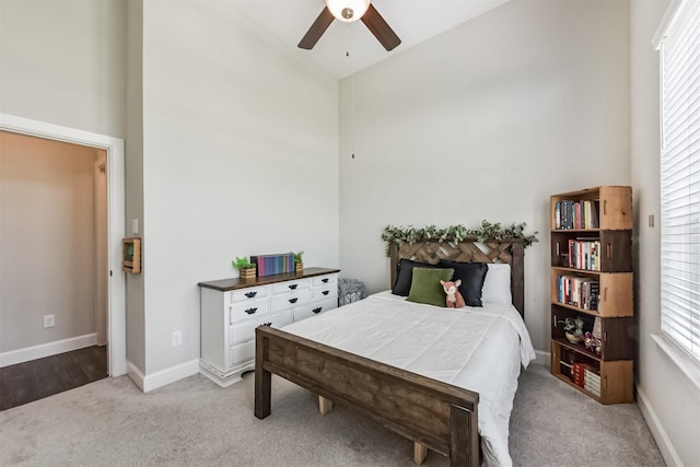 10119 Napier Dr, Iowa Colony, TX 77583 - bedroom featuring light carpet, a towering ceiling, and a ceiling fan