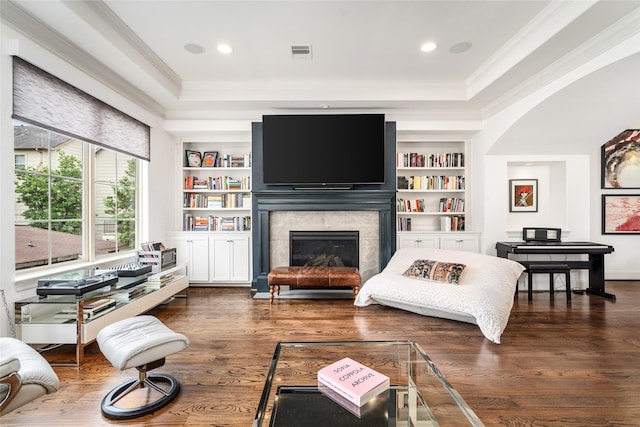1616 Nevada St, Houston, TX 77006 - living area with a tray ceiling, crown molding, a glass covered fireplace, built in shelves, and wood finished floors