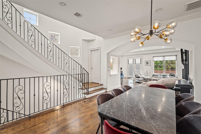 1616 Nevada St, Houston, TX 77006 - dining room with a chandelier, wood finished floors, arched walkways, recessed lighting, and ornamental molding