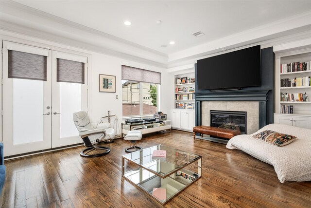 1616 Nevada St, Houston, TX 77006 - living area with french doors, wood finished floors, a glass covered fireplace, built in features, and recessed lighting