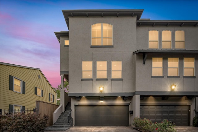 1616 Nevada St, Houston, TX 77006 - view of front facade featuring stucco siding and an attached garage