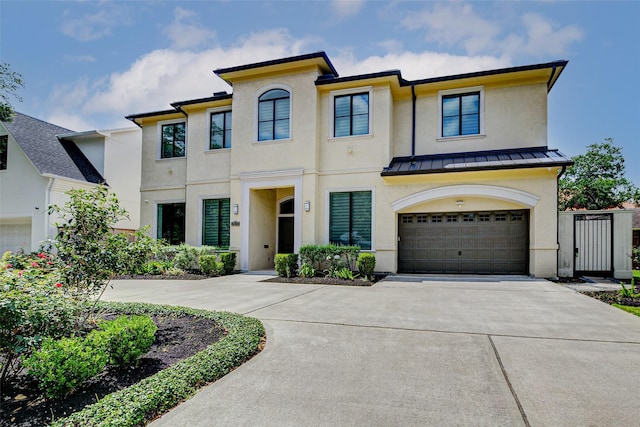 2822 Westgrove Ln, Houston, TX 77027 - view of front of home with a standing seam roof, stucco siding, concrete driveway, an attached garage, and a metal roof