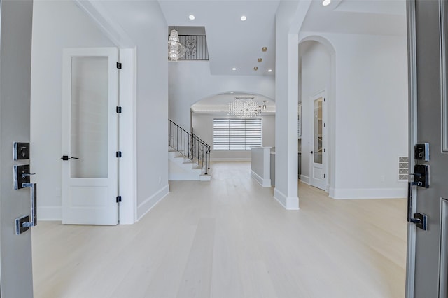 2822 Westgrove Ln, Houston, TX 77027 - entryway with light wood-style floors, a chandelier, arched walkways, stairway, and recessed lighting