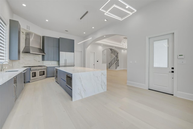 2822 Westgrove Ln, Houston, TX 77027 - kitchen featuring wall chimney exhaust hood, modern cabinets, built in appliances, gray cabinetry, and recessed lighting