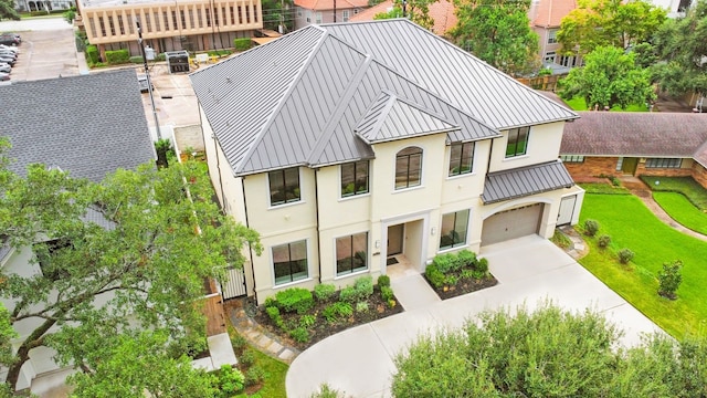 2822 Westgrove Ln, Houston, TX 77027 - view of front of property with stucco siding, an attached garage, a standing seam roof, concrete driveway, and a metal roof