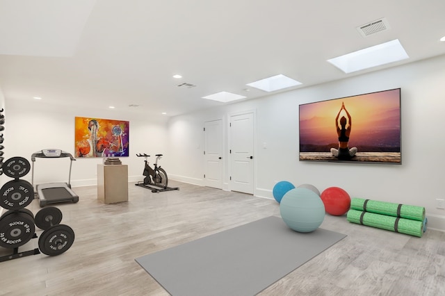 2822 Westgrove Ln, Houston, TX 77027 - workout area with a skylight, wood finished floors, and recessed lighting