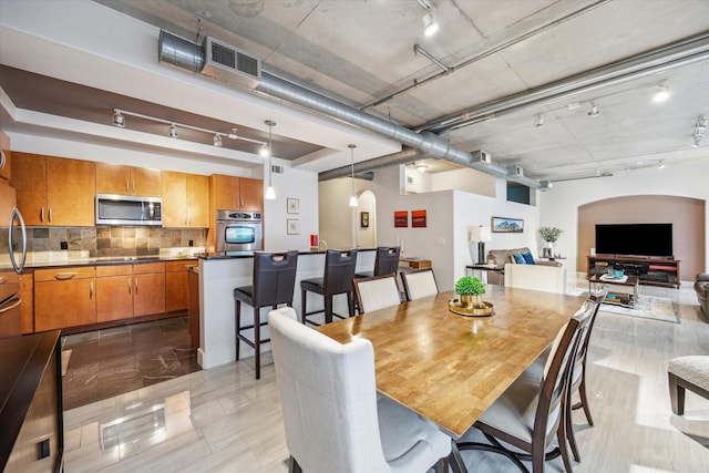 1901 Post Oak Blvd Unit 202, Houston, TX 77056 - dining area featuring track lighting and arched walkways