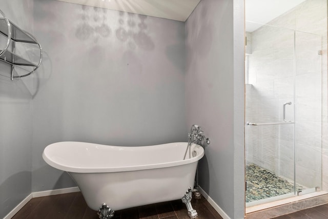 150 Lazy Ln, Livingston, TX 77351 - full bath with a stall shower, a freestanding tub, and wood finished floors