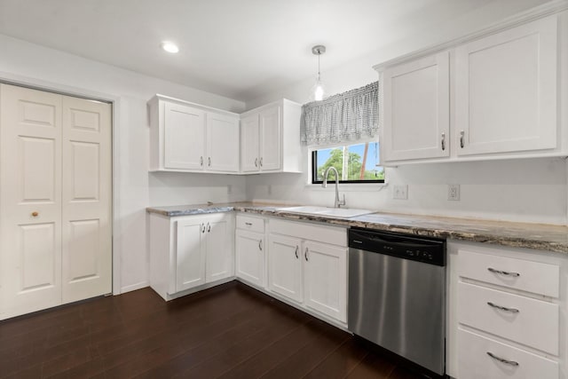 150 Lazy Ln, Livingston, TX 77351 - kitchen with stainless steel dishwasher, white cabinets, light stone countertops, dark wood-type flooring, and hanging light fixtures