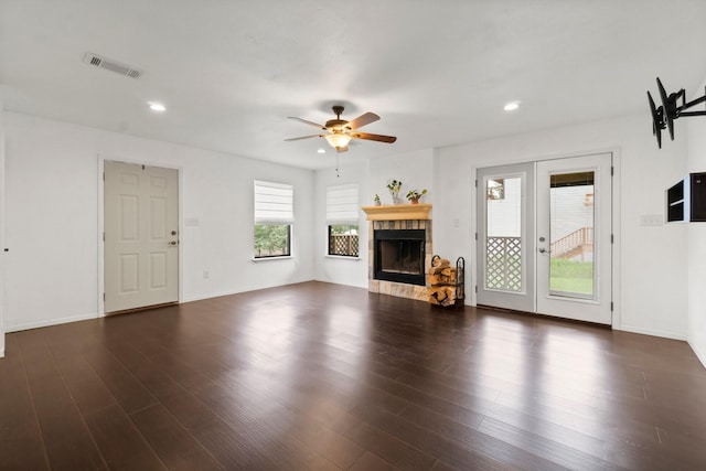 150 Lazy Ln, Livingston, TX 77351 - unfurnished living room with ceiling fan, a fireplace, wood finished floors, french doors, and recessed lighting