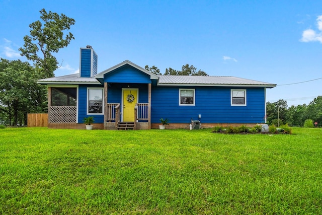 150 Lazy Ln, Livingston, TX 77351 - view of front facade with a front lawn, a metal roof, and a chimney