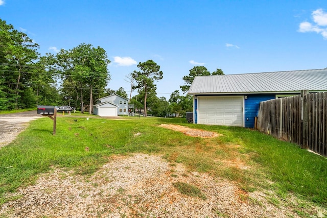 150 Lazy Ln, Livingston, TX 77351 - view of yard featuring a garage, an outbuilding, and driveway