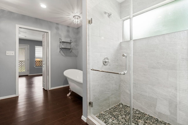 150 Lazy Ln, Livingston, TX 77351 - full bathroom featuring a stall shower, wood finished floors, and a soaking tub