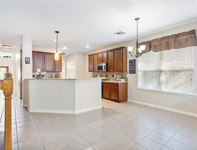 23931 Clover Trl, Katy, TX 77494 - kitchen with stainless steel microwave, a chandelier, light tile patterned floors, tasteful backsplash, and recessed lighting