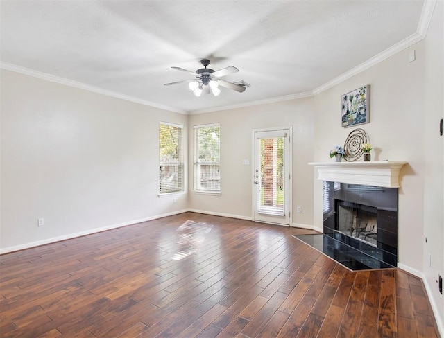 23931 Clover Trl, Katy, TX 77494 - unfurnished living room with a ceiling fan, a tiled fireplace, wood finished floors, and crown molding