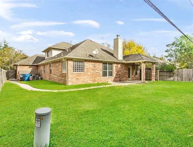 23931 Clover Trl, Katy, TX 77494 - rear view of property featuring a fenced backyard, a patio, brick siding, a chimney, and roof with shingles