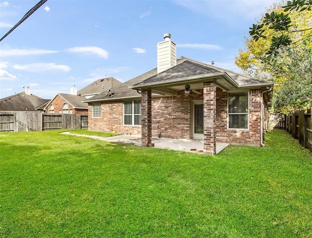 23931 Clover Trl, Katy, TX 77494 - back of property with a fenced backyard, a patio, brick siding, ceiling fan, and a chimney