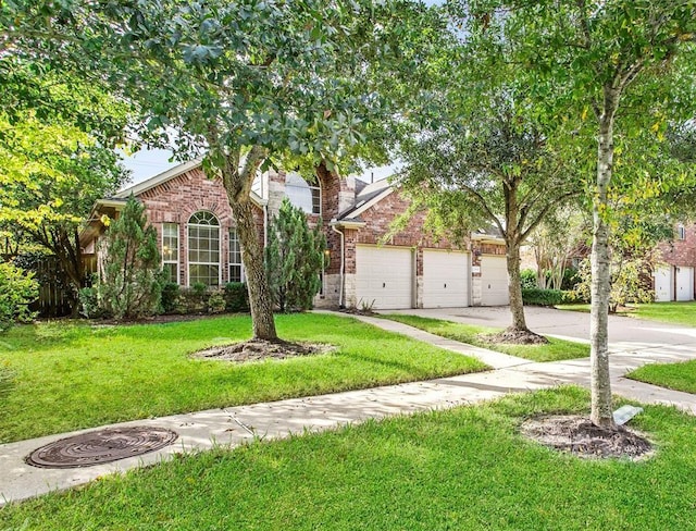 23931 Clover Trl, Katy, TX 77494 - obstructed view of property featuring brick siding, concrete driveway, and a front lawn