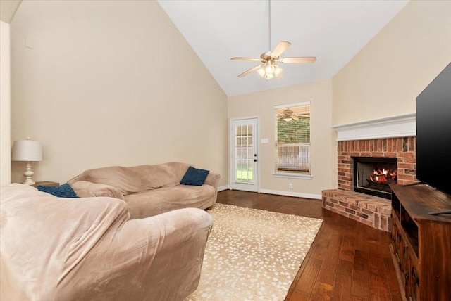 6835 Durango Creek Dr, Magnolia, TX 77354 - living room with vaulted ceiling, dark wood-type flooring, a brick fireplace, and a ceiling fan