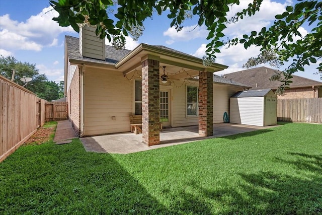 6835 Durango Creek Dr, Magnolia, TX 77354 - back of house with a shed, a ceiling fan, a patio, a fenced backyard, and a chimney