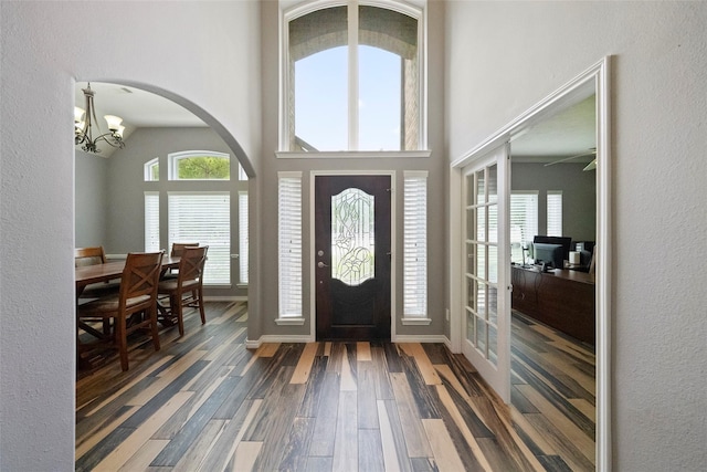 32926 Leafy Oak Ct, Magnolia, TX 77354 - foyer entrance featuring wood finished floors, a chandelier, plenty of natural light, and arched walkways