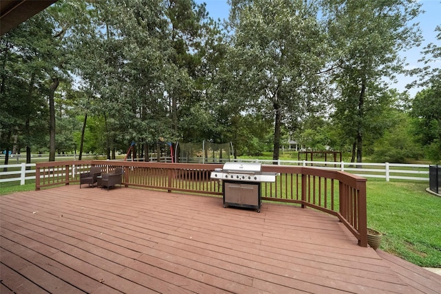 32926 Leafy Oak Ct, Magnolia, TX 77354 - wooden deck featuring a trampoline, a playground, view of scattered trees, and grilling area