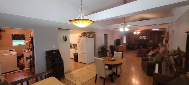 20 Connor Ln, Huntsville, TX 77320 - dining space featuring washer / dryer, vaulted ceiling, light wood finished floors, and a ceiling fan