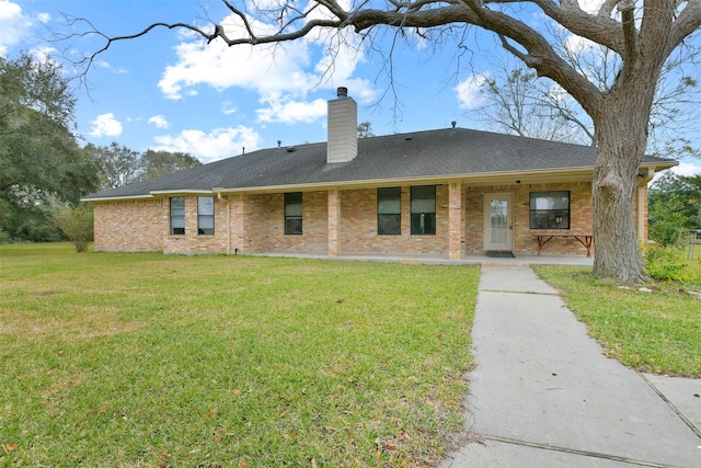 1628 Vauthier St, La Marque, TX 77568 - rear view of property featuring brick siding, a lawn, a chimney, a porch, and a shingled roof