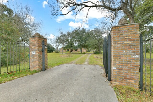 1628 Vauthier St, La Marque, TX 77568 - view of dirt / gravel road with a gate