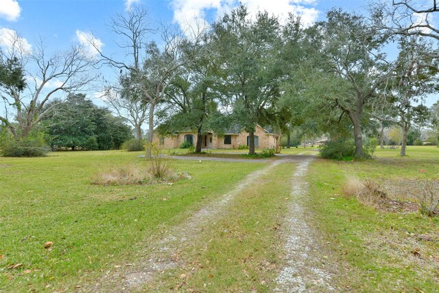 1628 Vauthier St, La Marque, TX 77568 - view of front of home featuring dirt driveway and a front lawn