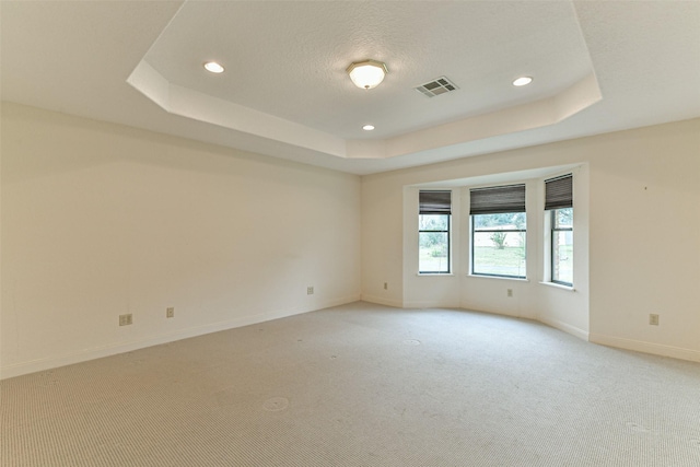 1628 Vauthier St, La Marque, TX 77568 - spare room featuring a tray ceiling, light carpet, and recessed lighting