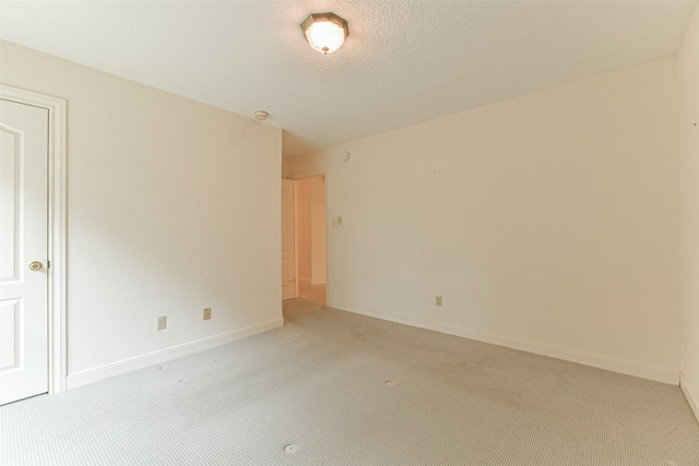 1628 Vauthier St, La Marque, TX 77568 - spare room with light colored carpet, a smoke detector, and a textured ceiling
