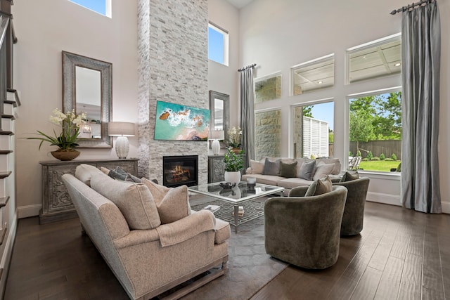 43 W Sawyer Ridge Dr, Spring, TX 77389 - living area featuring a towering ceiling, plenty of natural light, dark wood-type flooring, and a stone fireplace