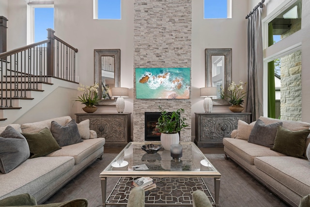 43 W Sawyer Ridge Dr, Spring, TX 77389 - living area featuring a towering ceiling, healthy amount of natural light, a fireplace, and stairway