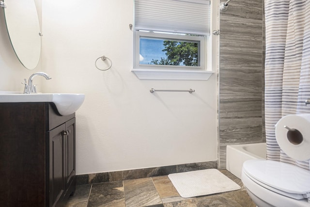 201 E 5th St, Deer Park, TX 77536 - bathroom featuring vanity, shower / tub combo, and stone tile floors