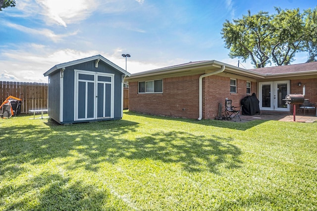 201 E 5th St, Deer Park, TX 77536 - back of property with french doors, a storage unit, brick siding, and a patio area