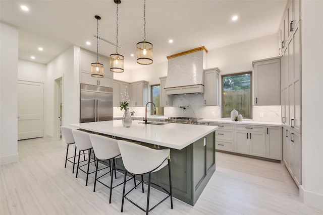 7106 Dearborn St, Houston, TX 77055 - kitchen featuring built in fridge, custom range hood, decorative backsplash, recessed lighting, and a large island