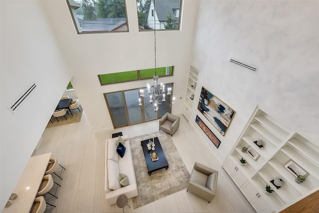 7106 Dearborn St, Houston, TX 77055 - living room with a towering ceiling, a chandelier, and built in features