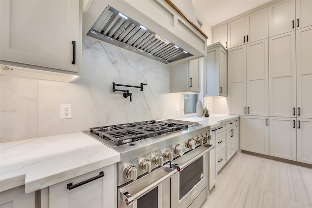 7106 Dearborn St, Houston, TX 77055 - kitchen with custom range hood, double oven range, decorative backsplash, and light stone counters