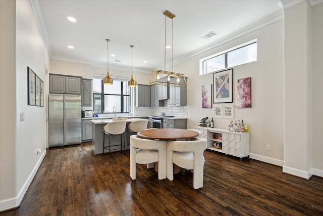 1207 W 24th St Unit A, Houston, TX 77008 - dining area featuring crown molding, dark wood-type flooring, and recessed lighting